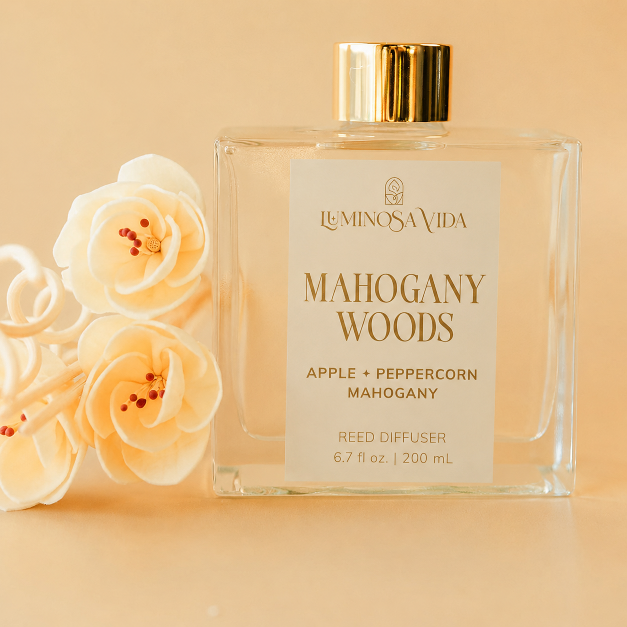 Luminosa Vida Mahogany Woods Reed Diffuser featuring warm notes of apple, peppercorn, and mahogany in a luxury glass bottle with decorative sola wood flowers, perfect for fall home fragrance and autumn décor.