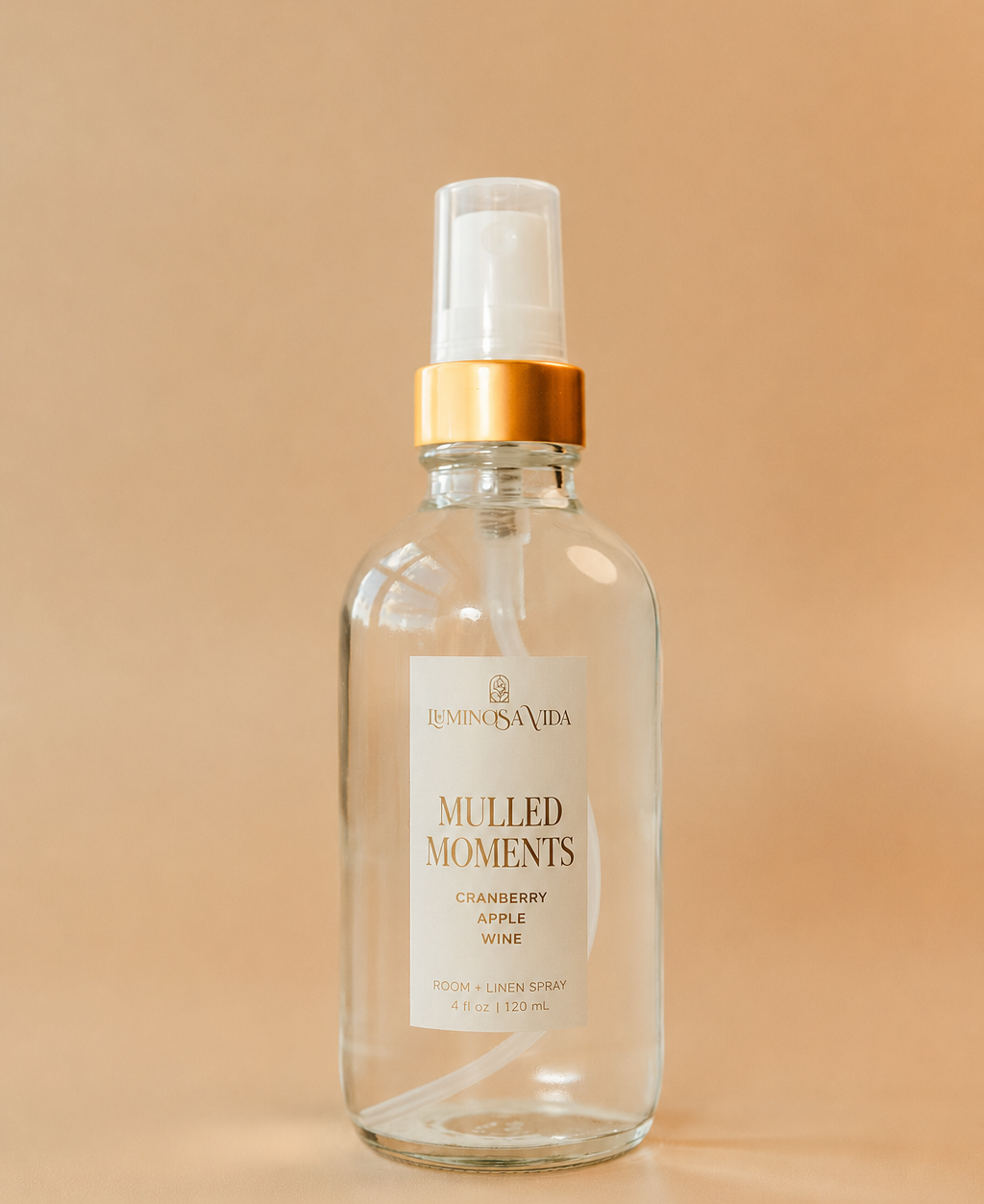 Mulled Moments Room & Linen Spray by Luminosa Vida featuring cranberry, apple and wine notes in a 6.7 oz luxury glass bottle with a gold fine mist sprayer.