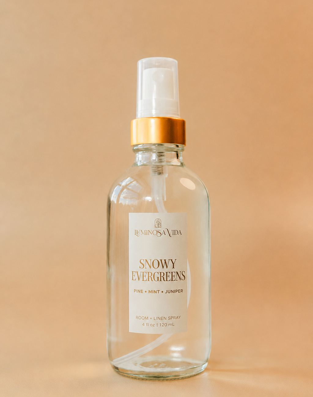 Luxury Snowy Evergreens room and linen spray featuring pine, mint and juniper in a minimalist glass bottle by Luminosa Vida.