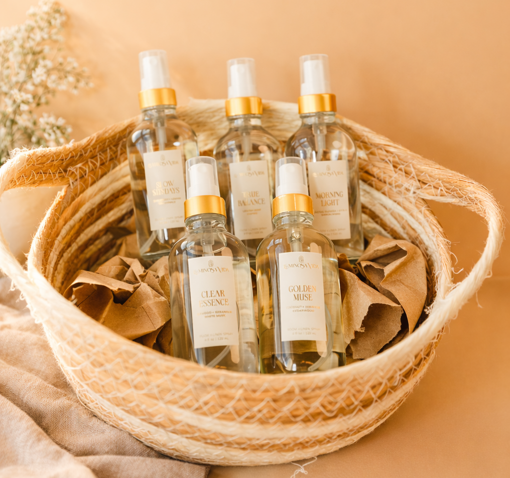 Luminosa Vida luxury room and linen spray collection styled in a woven basket with warm neutral tones.