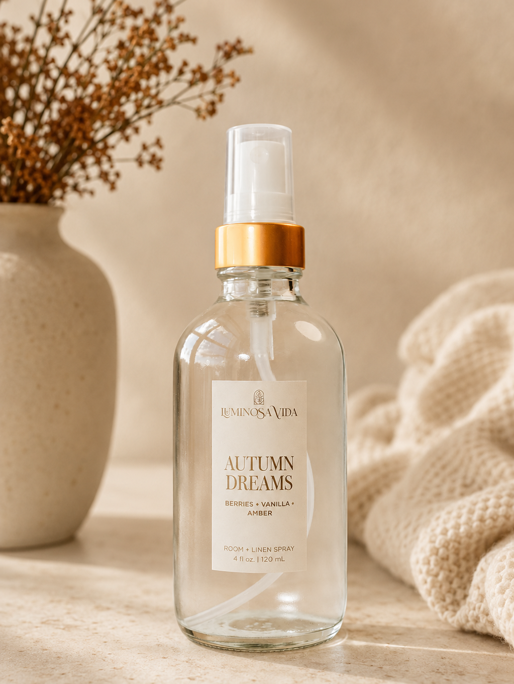Autumn Dreams Room & Linen Spray by Luminosa Vida in a cozy neutral home setting featuring berries, vanilla, and amber notes. Clean, phthalate-free room spray for refreshing linens and creating a warm fall home fragrance.