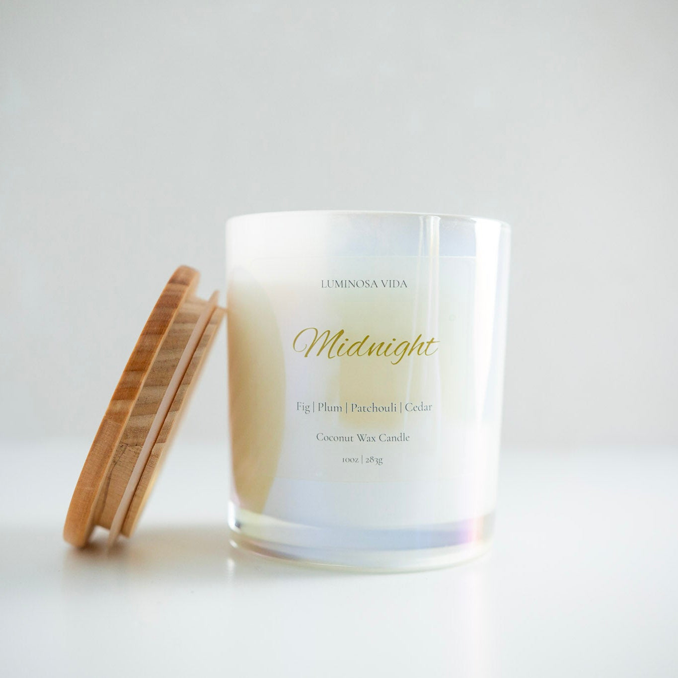 “Luminosa Vida Midnight candle in an iridescent glass jar with a wood lid, featuring gold lettering and minimalist label design. Luxury coconut wax candle handcrafted in Austin, Texas with notes of fig, plum, patchouli, and cedar.”

This version balances clarity, accessibility, and search relevance — optimized for terms like luxury candle, coconut wax, Austin handmade, and Luminosa Vida.