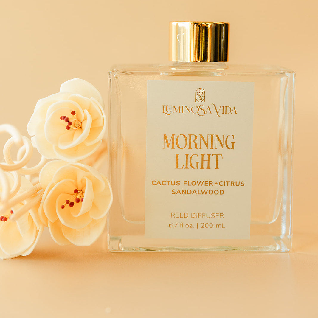 Luminosa Vida Morning Light reed diffuser with cactus flower, citrus and sandalwood fragrance in a clear glass bottle with gold lid.