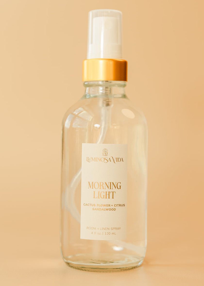 Luminosa Vida Morning Light room and linen spray with cactus flower, citrus, and sandalwood in a clear glass bottle.
