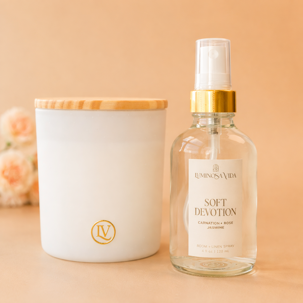 Luminosa Vida Soft Devotion room and linen spray with carnation, rose, and jasmine next to a luxury coconut wax candle with bamboo lid.