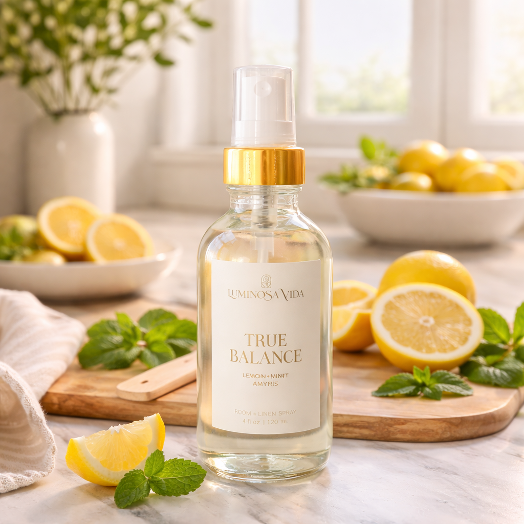 Luminosa Vida True Balance room and linen spray with lemon, mint, and amyris styled in a bright kitchen with fresh lemons and mint leaves.