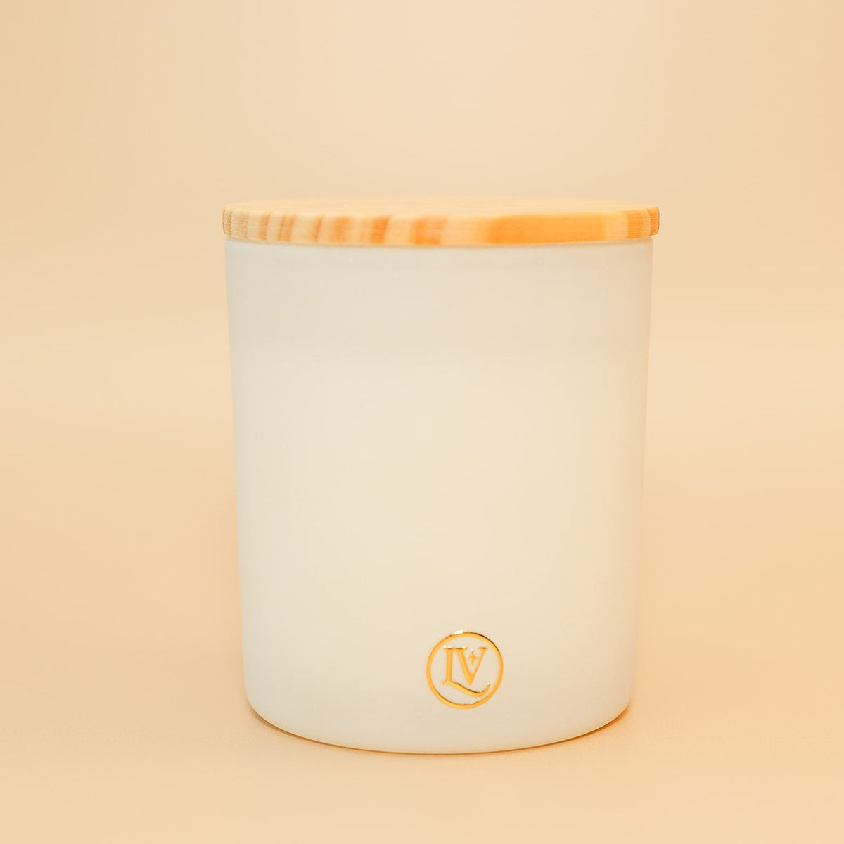 Quiet Hour luxury coconut wax candle by Luminosa Vida in a frosted white glass vessel with a natural wood lid, featuring notes of creamy vanilla, lavender, and smoky woods for a calming home fragrance experience.